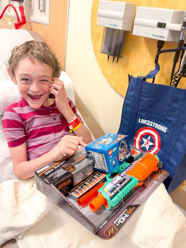 Wilder laughing with new toys at a clinic visit